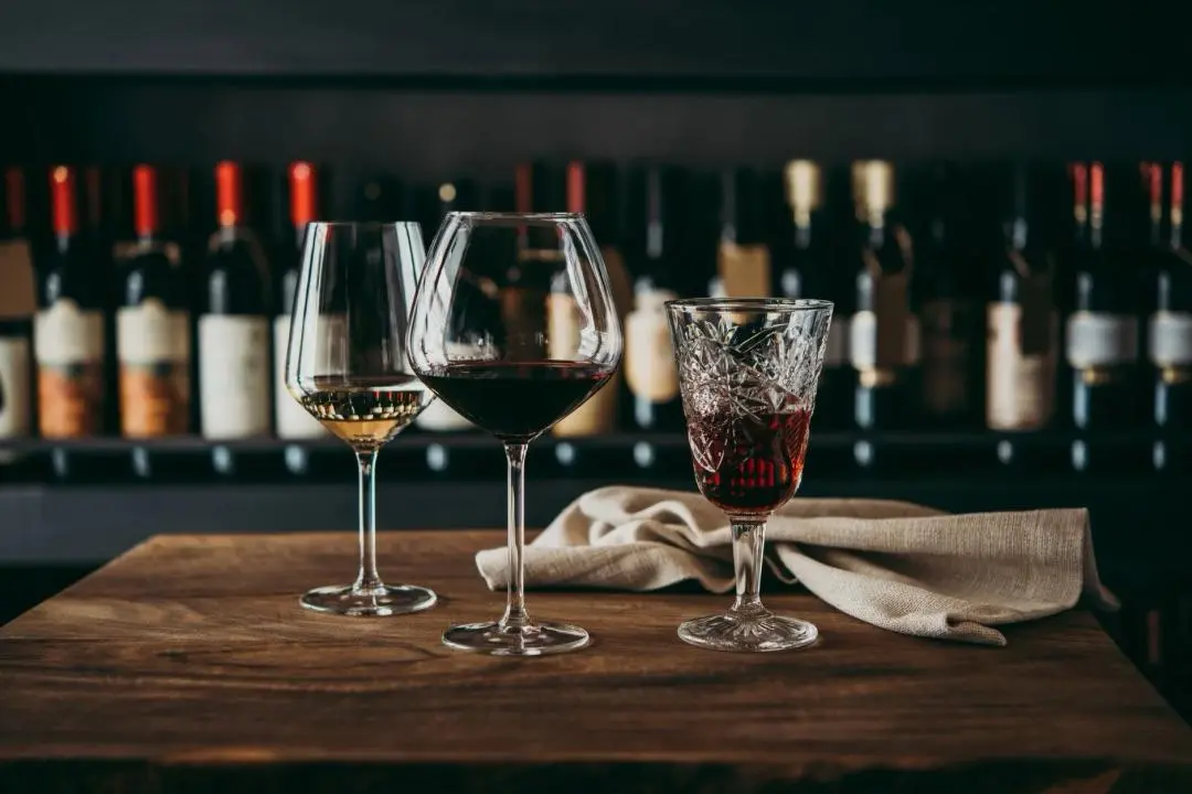 A glass of wine on a table, used as a background image